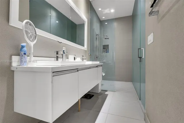 a bathroom with a double vanity sink and a mirror