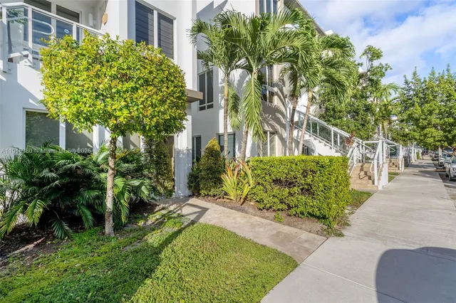 a view of a garden with a building in the background