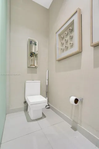 a white toilet sitting next to a bathroom sink