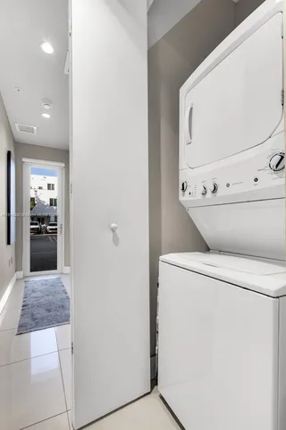 a view of washer and dryer with kitchen in the background
