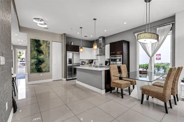 a view of kitchen with stainless steel appliances granite countertop a stove and refrigerator