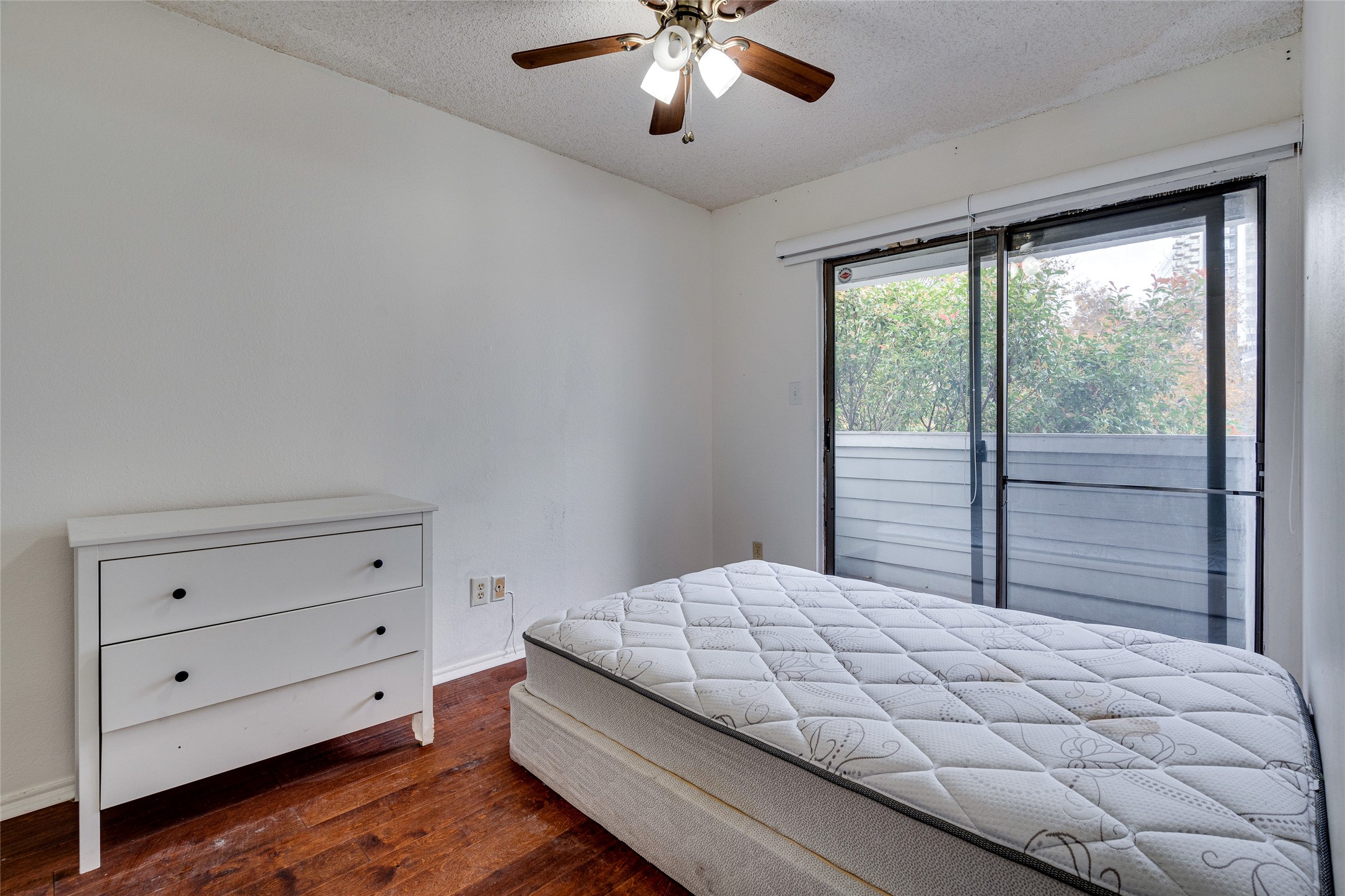 1808 Rio Grande Street, Unit 6 Austin, TX 78701 - Photo 15 of 29 Bedroom with access to outside, dark wood finished floors, a textured ceiling, and ceiling fan