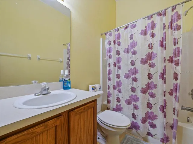 a bathroom with a toilet sink and a mirror