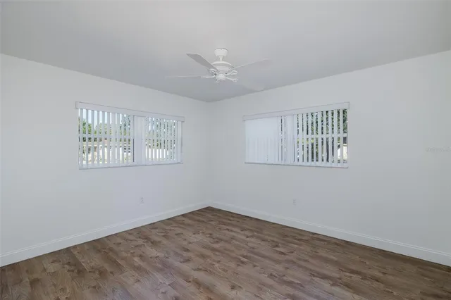 a view of a kitchen with a sink and dishwasher with wooden floor