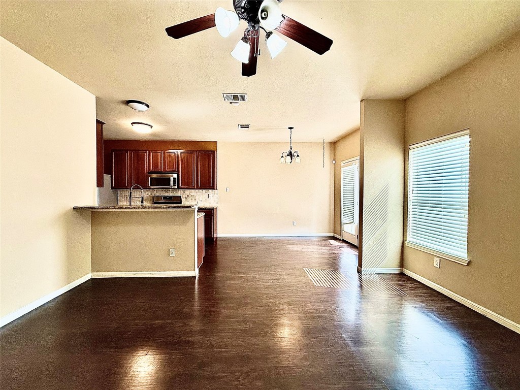 1900 Little Elm Trail, Unit 105 Cedar Park, TX 78613 - Photo 11 of 31 a view of a kitchen with a sink wooden cabinet and a refrigerator