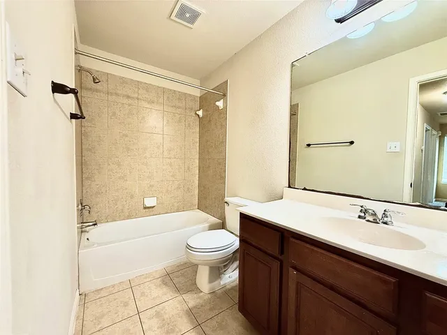 a bathroom with a sink a toilet a mirror and shower