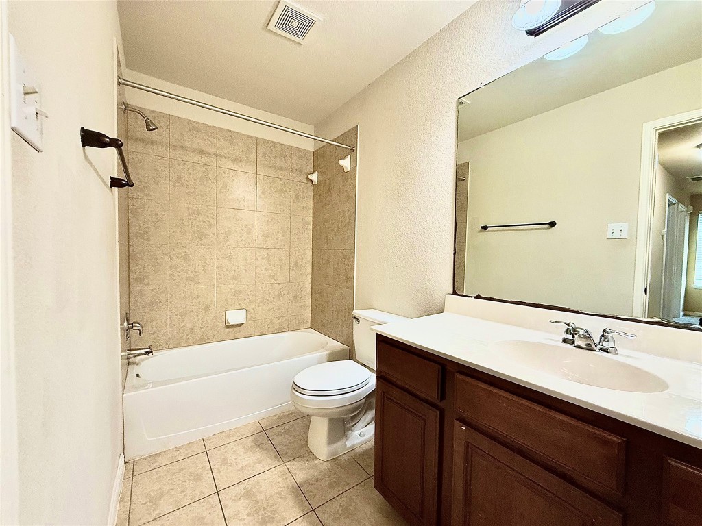 1900 Little Elm Trail, Unit 105 Cedar Park, TX 78613 - Photo 20 of 31 a bathroom with a sink a toilet a mirror and shower