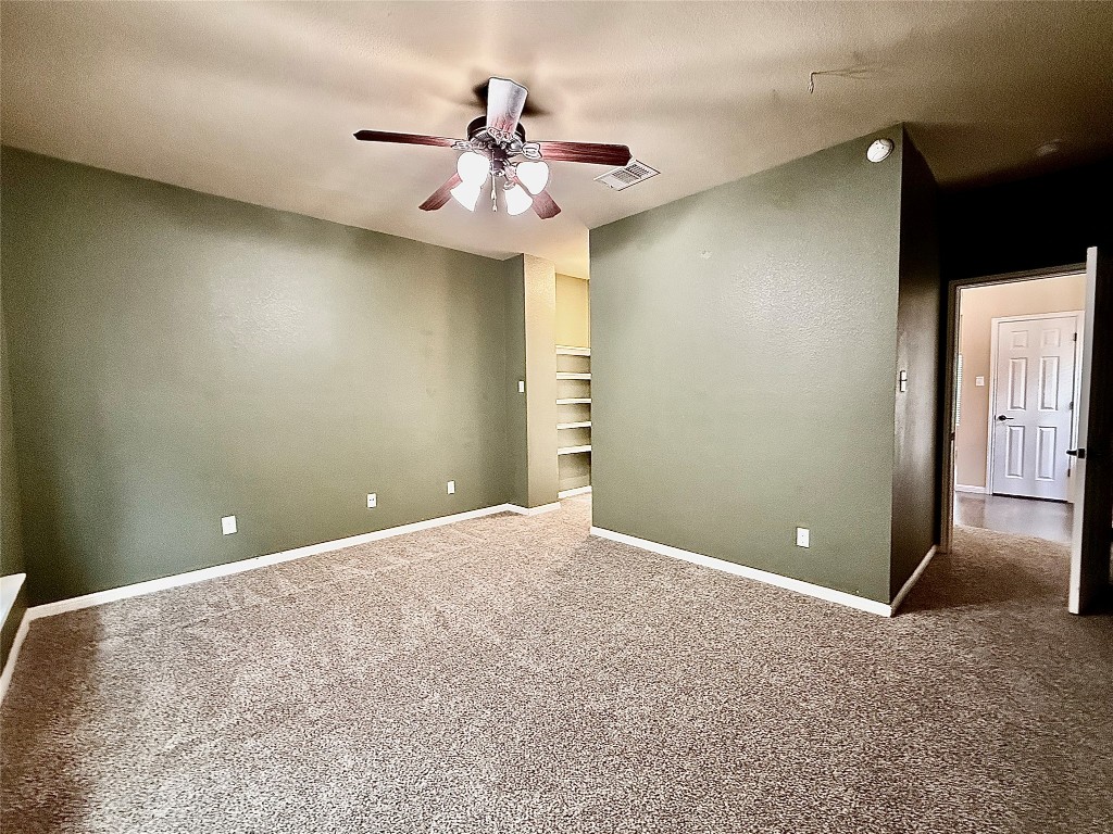 1900 Little Elm Trail, Unit 105 Cedar Park, TX 78613 - Photo 6 of 31 an empty room and chandelier fan