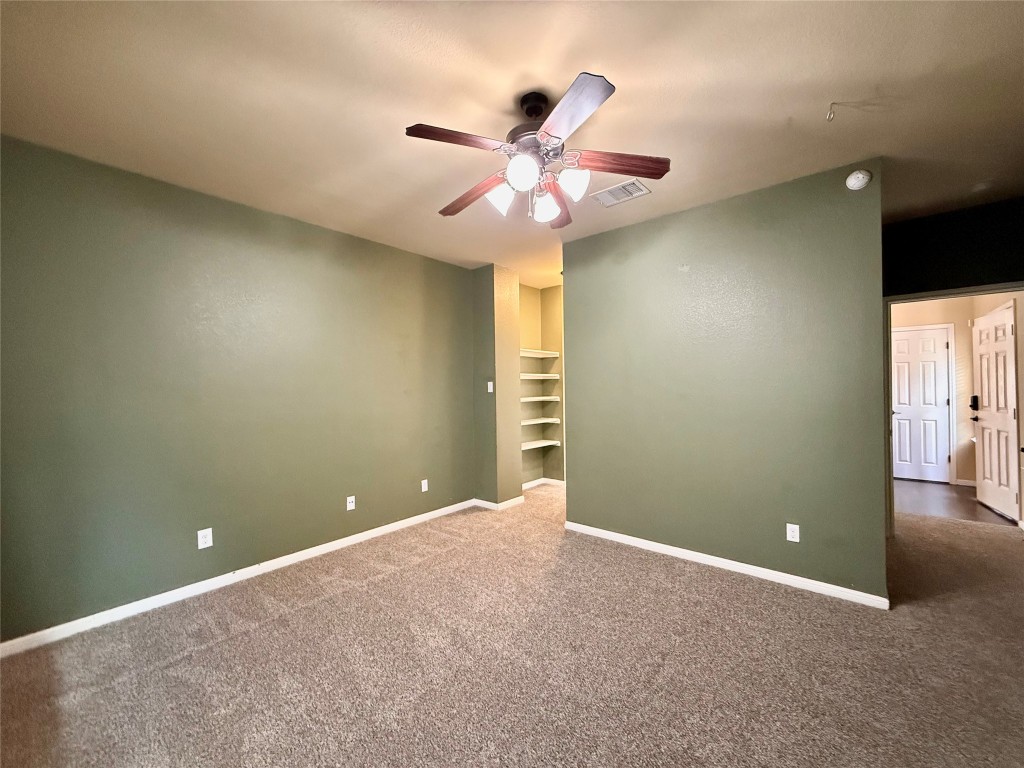 1900 Little Elm Trail, Unit 105 Cedar Park, TX 78613 - Photo 7 of 31 an empty room and chandelier fan