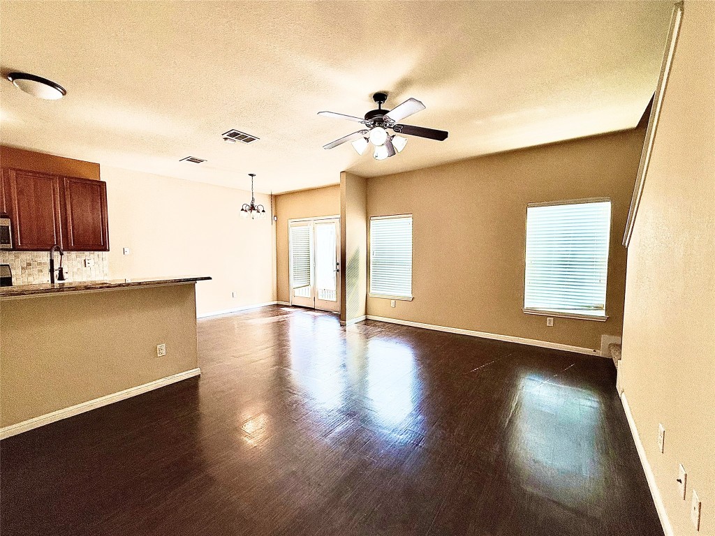 1900 Little Elm Trail, Unit 105 Cedar Park, TX 78613 - Photo 10 of 31 a view of an empty room with wooden floor and a window