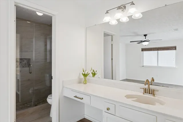 a bathroom with a double vanity sink mirror and shower