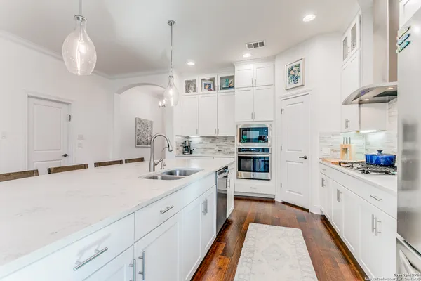 a kitchen with kitchen island a sink and appliances
