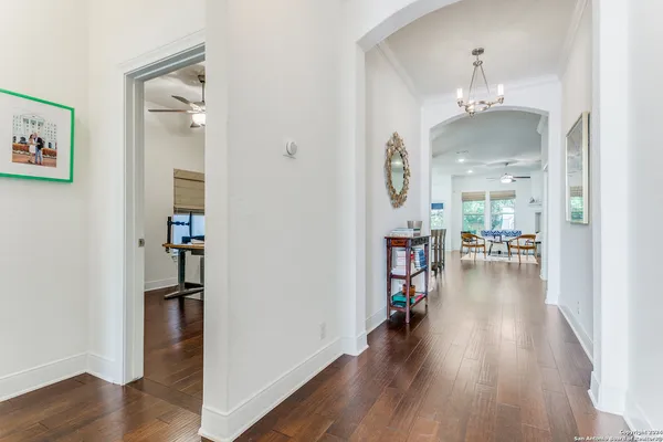 wooden floor in a livingroom and a chandelier