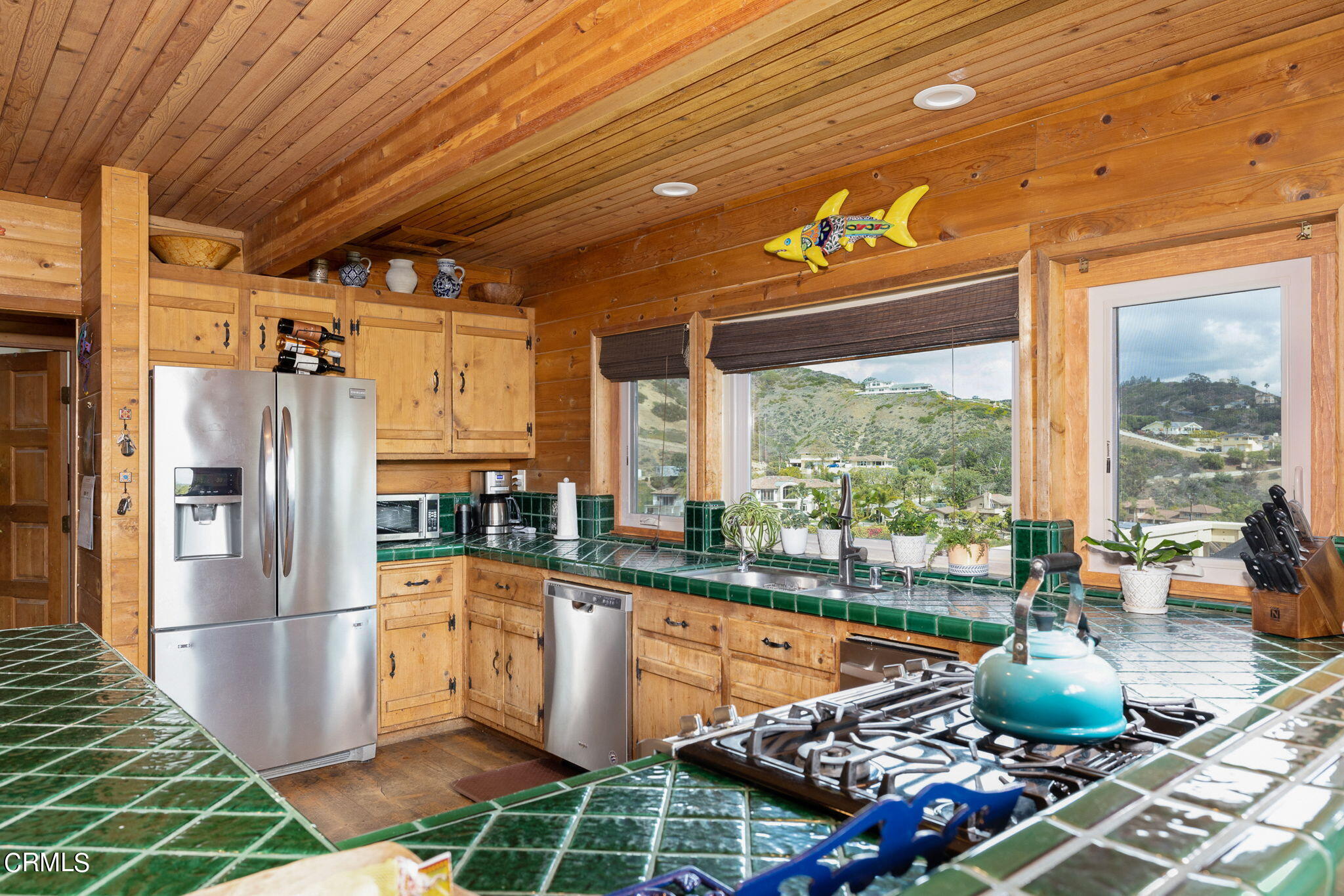 22 Santa Cruz Way Camarillo, CA 93010 - Photo 16 of 58 a kitchen with stainless steel appliances granite countertop a stove a refrigerator a sink and dishwasher with wooden floor
