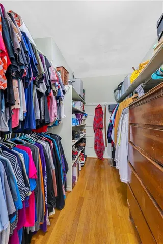 a bathroom with a granite countertop tub sink and mirror