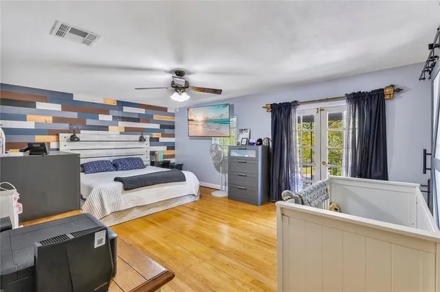 a bedroom with a bed and a chandelier