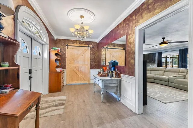 a view of a dining room with furniture and a chandelier