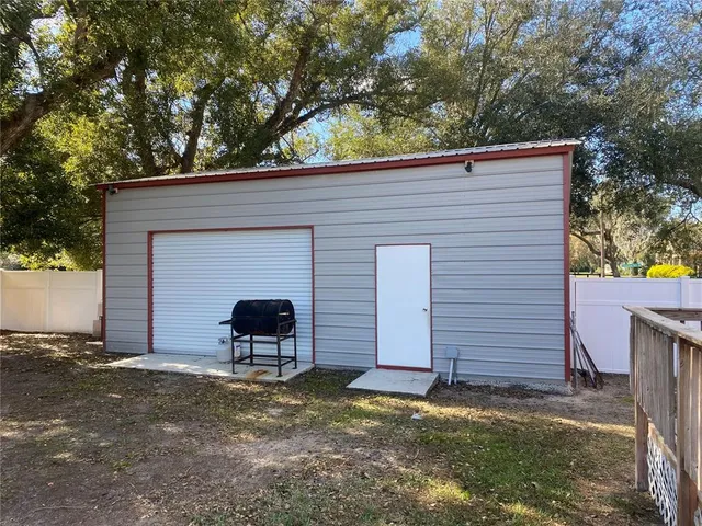 a view of a patio with table and chairs and potted plants