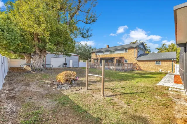 a view of a house with a yard patio and swimming pool