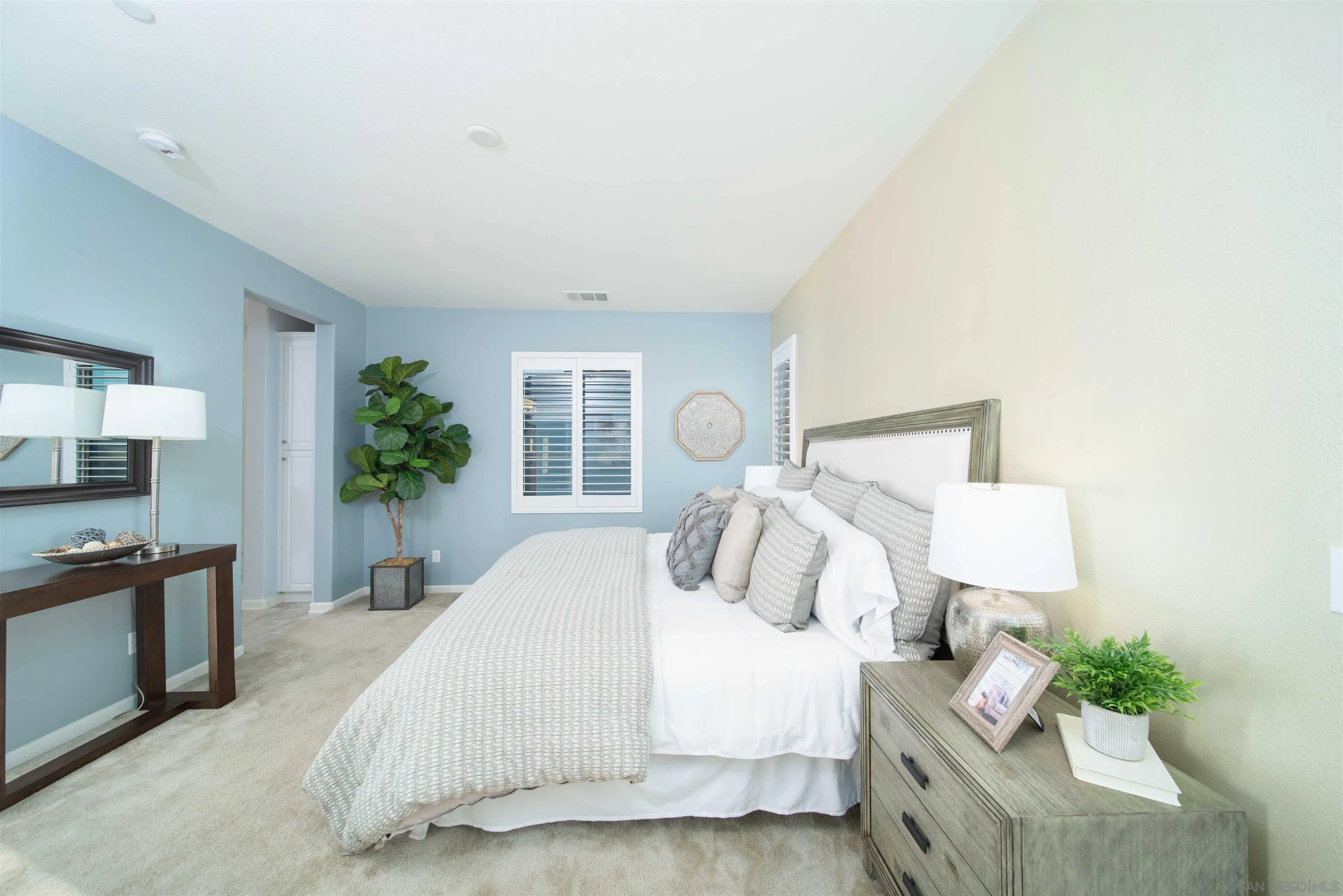 31556 Alicante Loop Winchester, CA 92596 - Photo 16 of 46 a bedroom with a bed and a potted plant on the dresser