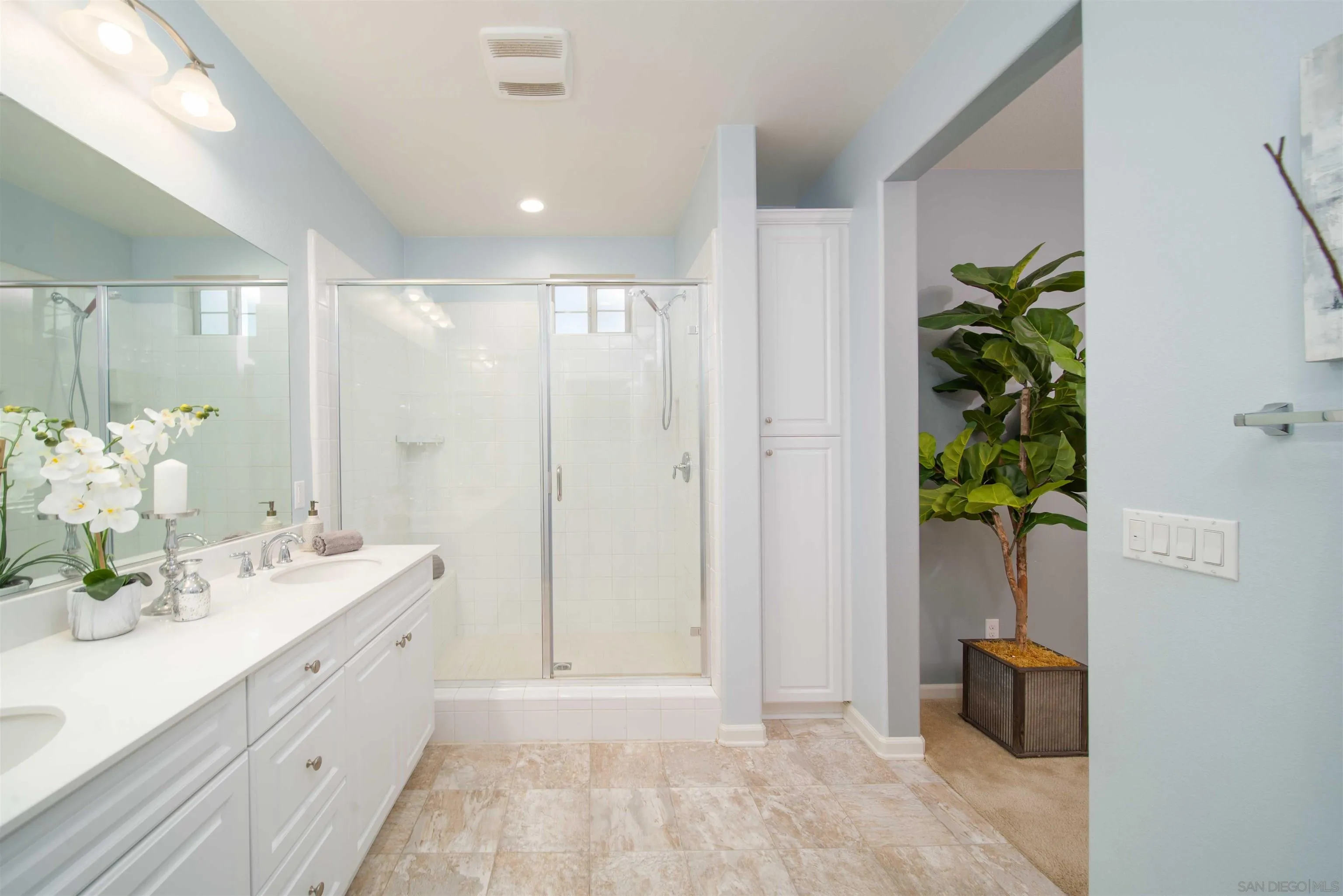 31556 Alicante Loop Winchester, CA 92596 - Photo 20 of 46 a spacious bathroom with a double vanity sink and a mirror