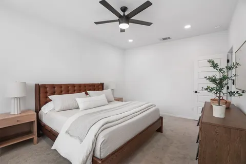 a bedroom with bed and a potted plant