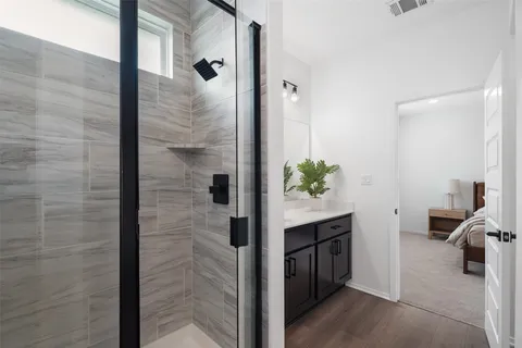 a bathroom with a shower and a sink