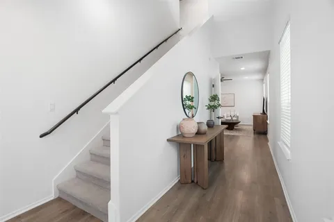 a view of entryway and hall with wooden floor