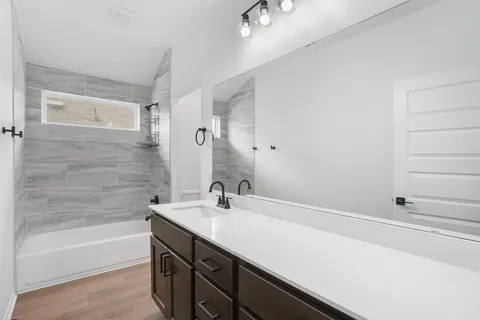 a bathroom with a sink a bathtub and a shower