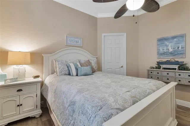 a spacious bedroom with a bed and a chandelier
