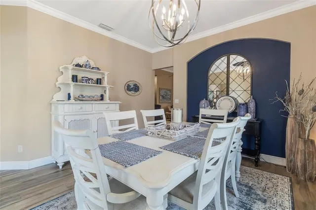 a dining room with furniture and wooden floor