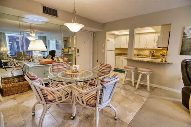 a living room with furniture and kitchen view