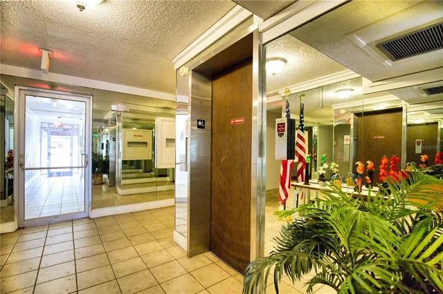 a living room with furniture a chandelier and a flat screen tv