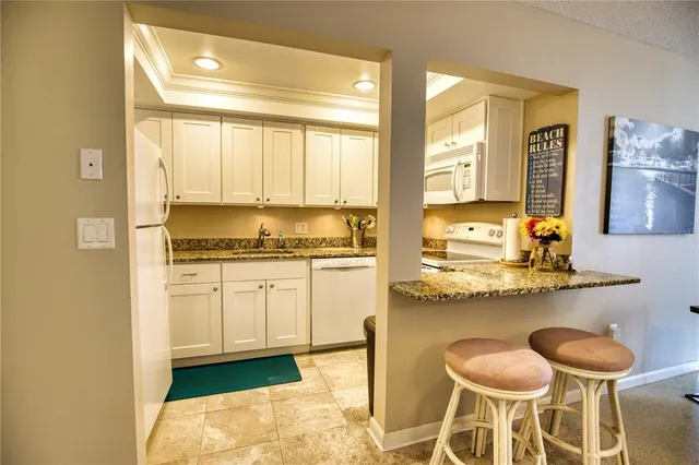 a kitchen with a sink a stove and cabinets