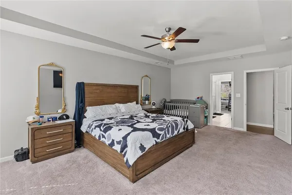 a bedroom with a bed and a chandelier