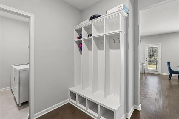 a view of an empty room with wooden floor and a cabinet