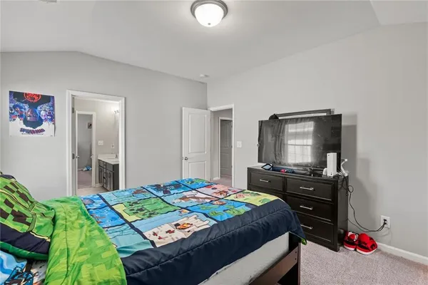 a bedroom with a bed and a dresser