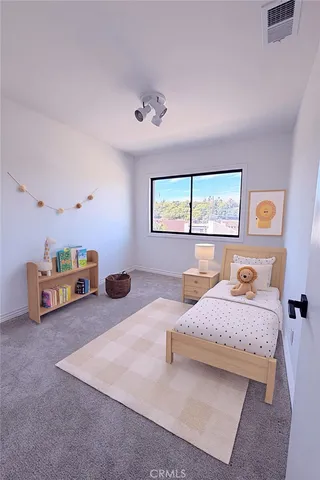 a bedroom with a bed and a dresser