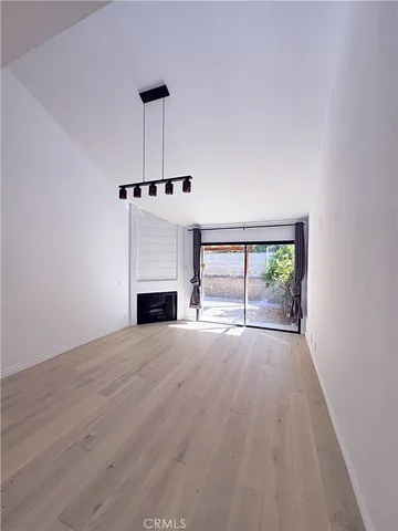a view of empty room with a fireplace