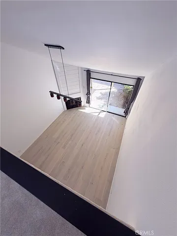 a view of a room with wooden floor