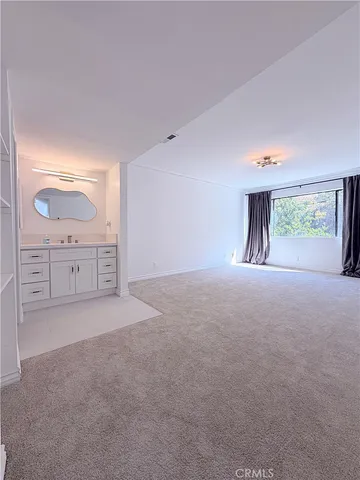 a room with a cabinets and a mirror