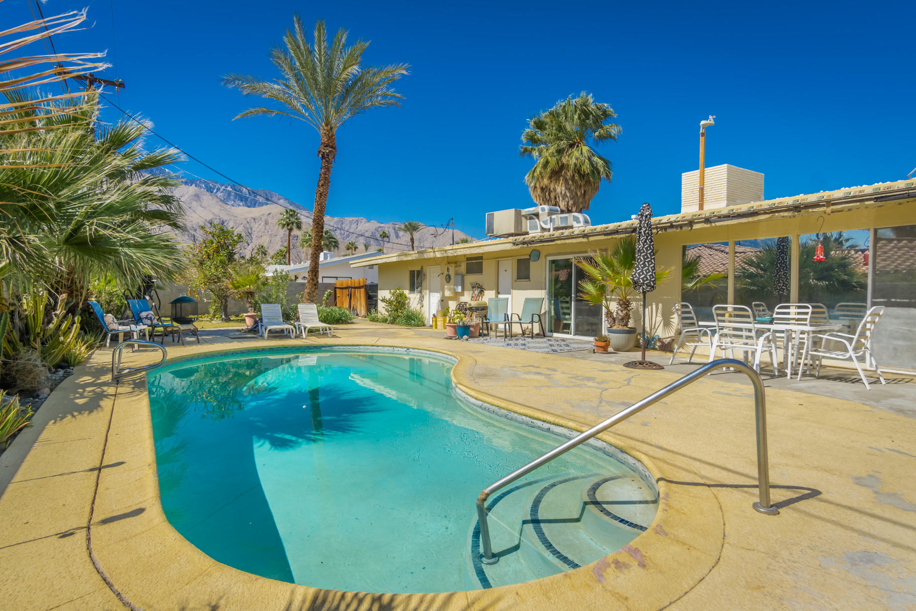 a view of a swimming pool with a chairs