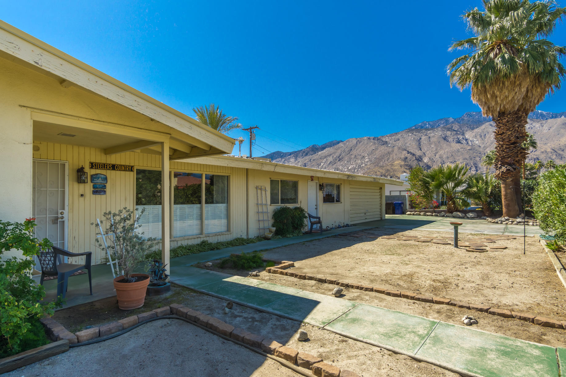 1225 Pasatiempo Road Palm Springs, CA 92262 - Photo 2 of 17 a front view of a house with garden