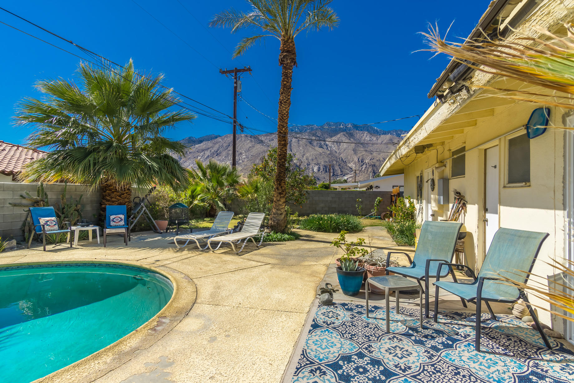 1225 Pasatiempo Road Palm Springs, CA 92262 - Photo 17 of 17 a view of a patio with a table and chairs under an umbrella