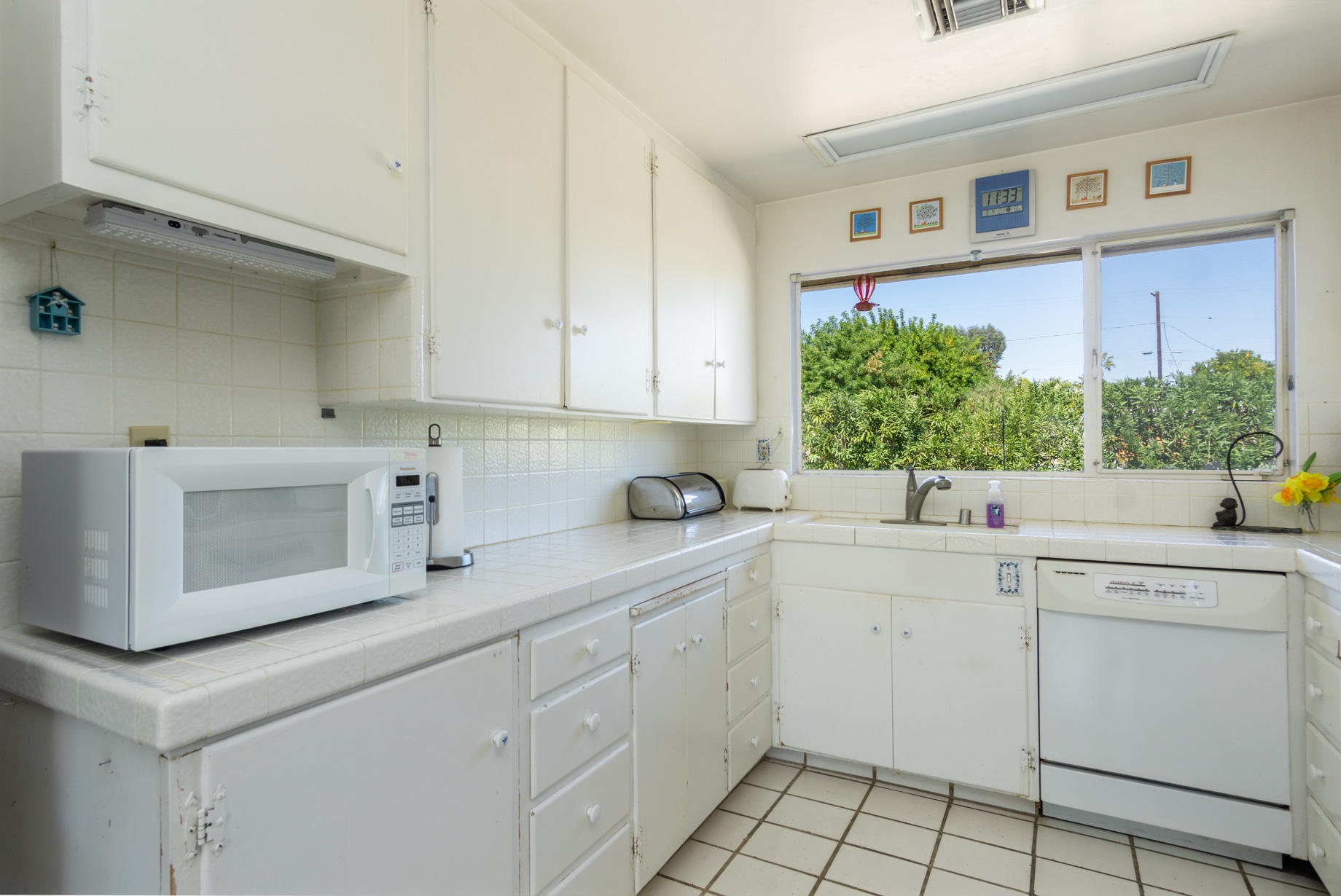 1225 Pasatiempo Road Palm Springs, CA 92262 - Photo 7 of 17 a kitchen with a sink cabinets and window