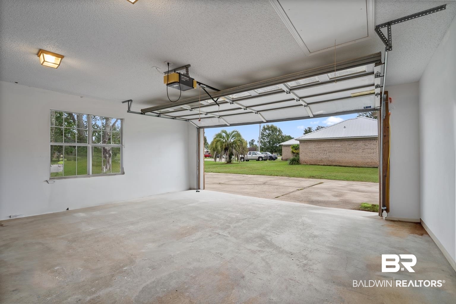 16418 Avent Lane Foley, AL 36535 - Photo 27 of 30 Garage with a lawn