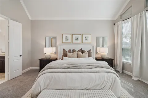 a bedroom with a bed and a lamp