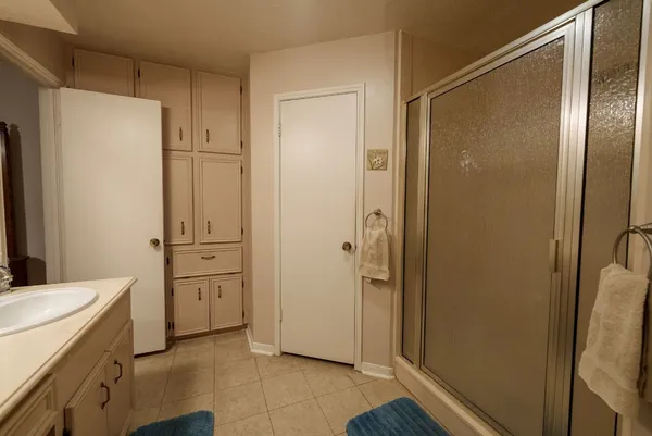 a bathroom with a granite countertop sink mirror and shower