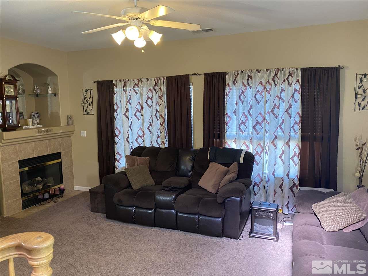 1487 Orca Way Reno, NV 89506 - Photo 6 of 16 a living room with furniture and a fireplace