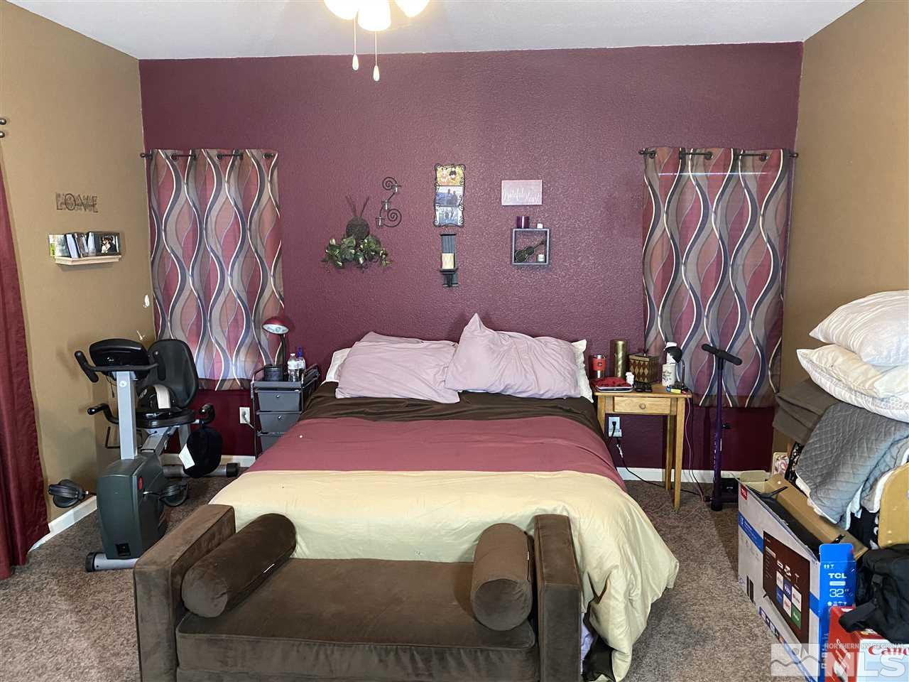 1487 Orca Way Reno, NV 89506 - Photo 8 of 16 a bedroom with a bed and wooden floor